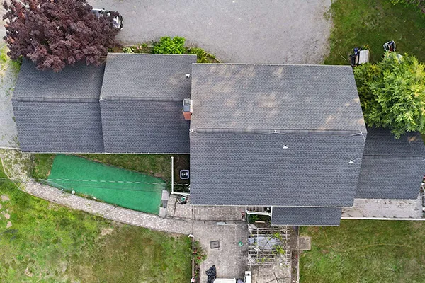 Aerial view of completed dark shingle roof on multi-section Connecticut house