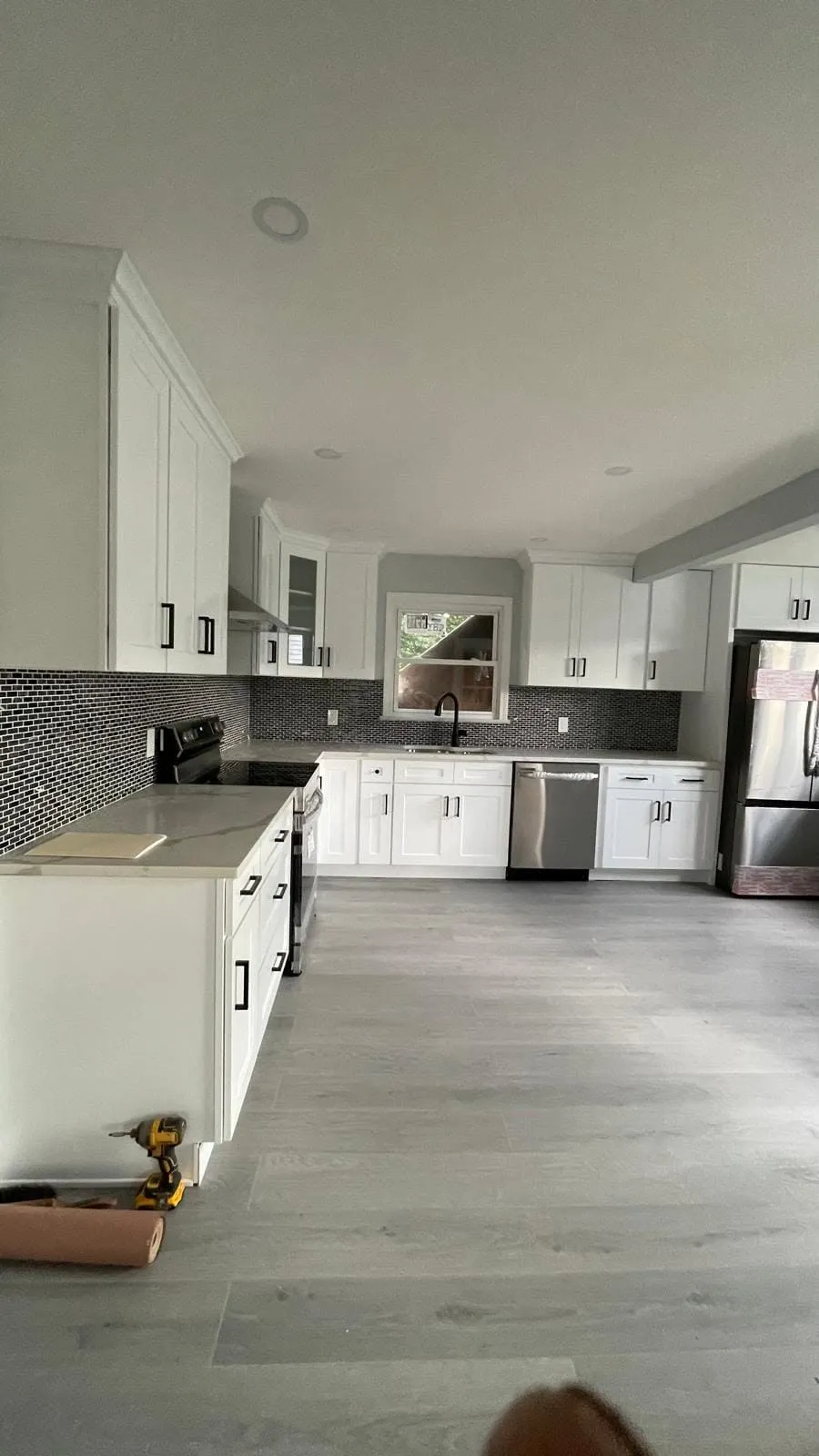 Finished white kitchen with white shaker cabinets and mosaic tile backsplash in Connecticut